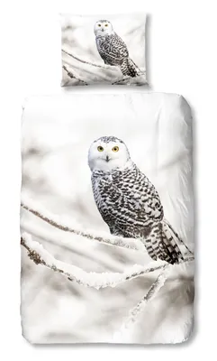 A duvet cover and pillowcase set featuring a snowy owl perched on a snow-covered branch.