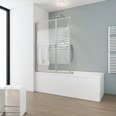 A modern bathroom with a bathtub and shower screen.