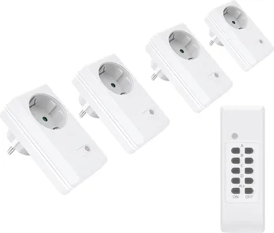 A set of four white wireless electrical outlets and a white remote control are arranged on a white background.
