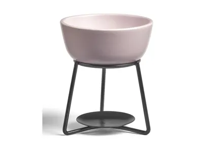 A pink ceramic bowl on a black metal stand with a tealight holder underneath, isolated on a white background.