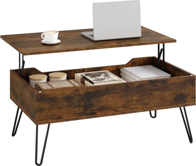 A lift-top coffee table with storage, a laptop, and a cup of coffee.