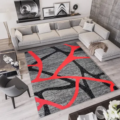 A modern living room with a sectional sofa, rug, and coffee table.