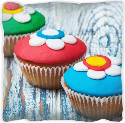 Produktbild von Wallario Premium Kissen, weiche Oberfläche, mit Motiv Bunte Muffins - alter Holztisch - Stillleben, Größe: 60 x 60 cm, mit weißer Rückseite