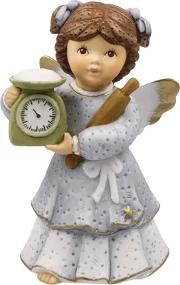 A ceramic figurine of an angel holding a rolling pin and a kitchen scale.