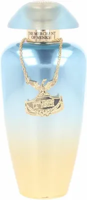 A perfume bottle with a gold chain and pendant.