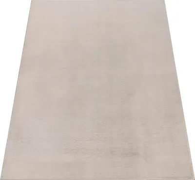 A plain, light gray rug is shown from a diagonal angle against a white background.