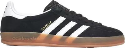 A side view of a black Adidas Gazelle sneaker with white stripes and a gum sole.