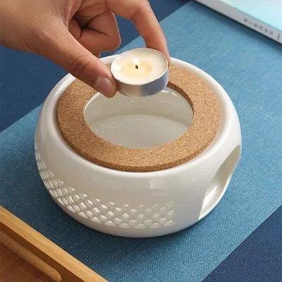 Zdjęcie produktu dla Ceramiczny podgrzewacz do herbaty w kolorze białym z korkową pokrywką