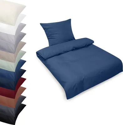 A stack of folded bedding in various colors and a single set of blue bedding laid out.