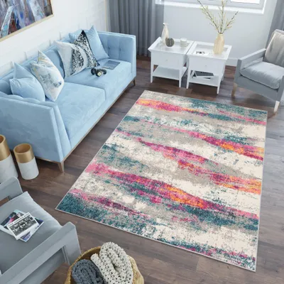A living room scene with a blue sofa, a rug, and side tables.