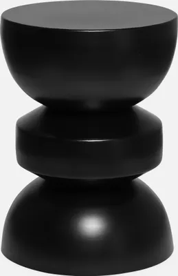 A black, hourglass-shaped side table is shown against a white background.