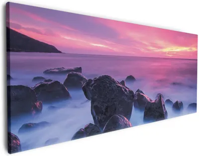 Produktbild von Wallario Premium Leinwandbild Felsen im Meer bei Sonnenuntergang in Größe 60 x 150 cm