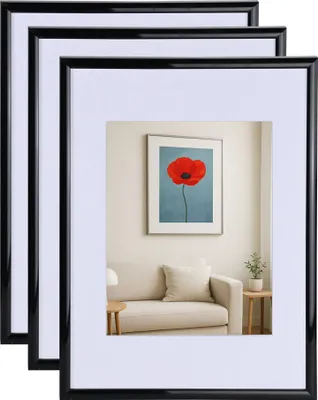 A room interior with a sofa and artwork on the wall, showcasing picture frames.