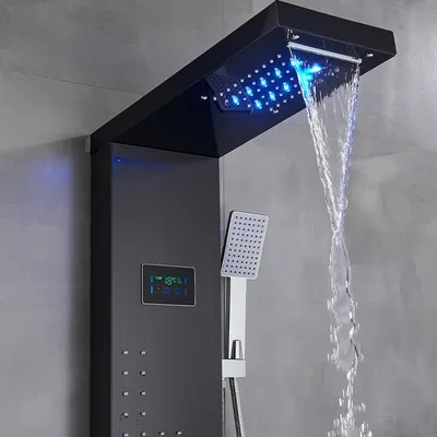 A modern black shower panel with a waterfall showerhead and LED lights, displaying water flow and temperature.