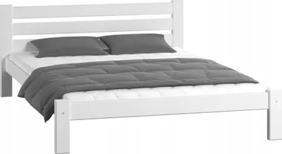 A white wooden bed frame with a mattress, two pillows, and a comforter.