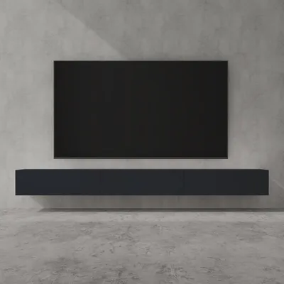 A modern, minimalist living room setup featuring a wall-mounted TV and a lowboard media console against a concrete wall.