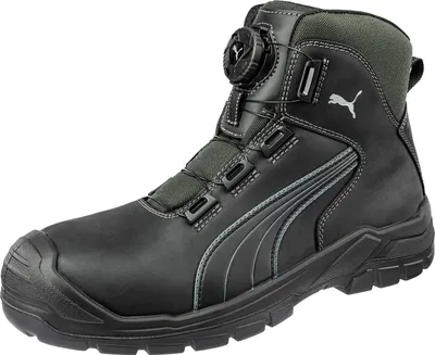 A black Puma safety boot with a gray sole and gray accents, shown against a white background.