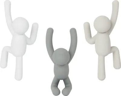 Three wall hooks shaped like stylized human figures in different colors.