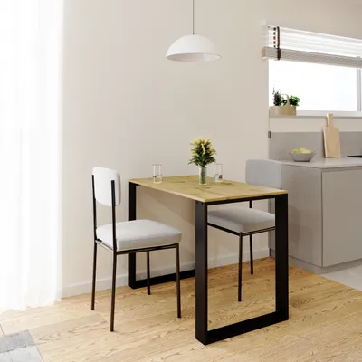 A small dining table with two chairs in a modern kitchen setting.