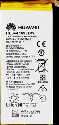 A close-up of a Huawei battery with product information and safety symbols.