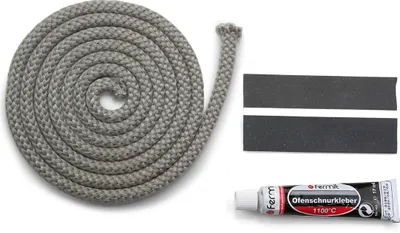 A coiled gray rope, two black strips with white lines, and a tube of adhesive are laid out on a white background.