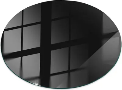 A circular black glass plate with reflections of a grid pattern.