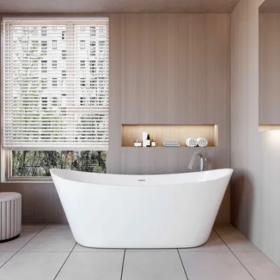 A modern bathroom with a freestanding bathtub, window with blinds, and a built-in shelf with toiletries and towels.