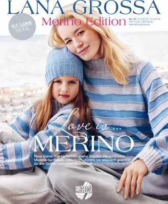 A mother and daughter are sitting together, both wearing matching striped sweaters and the daughter is wearing a hat. They are outdoors, possibly near a beach.