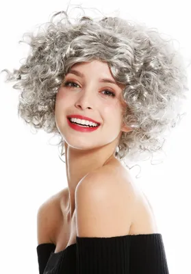 A woman wearing a wig is shown from the chest up against a white background.