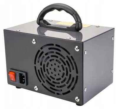 A gray ozonator with a black handle and a red power switch.