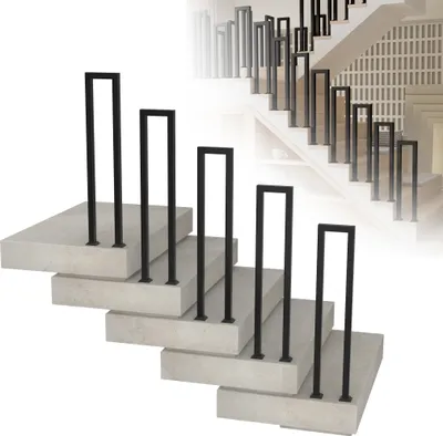 A set of black U-shaped stair railings are displayed on concrete steps.