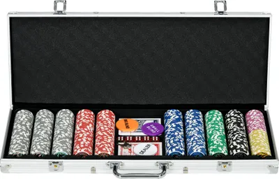 An open poker case filled with poker chips, cards, dice, and buttons.