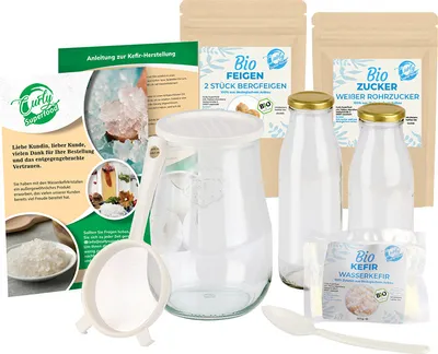 A collection of items for making Wasserkefir, including kefir grains, sugar, figs, bottles, a jar, and a sieve.