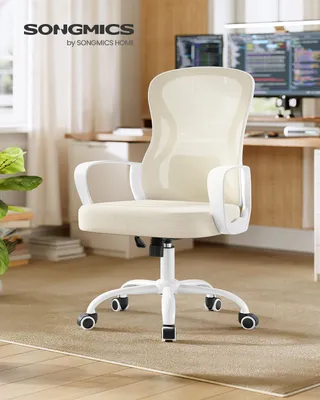 A cream-colored ergonomic office chair with a mesh back and white armrests and base is shown in a home office setting.
