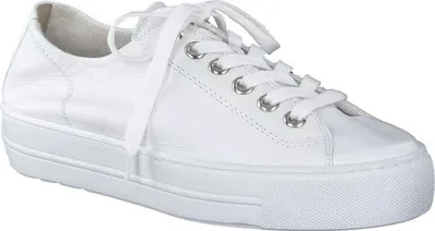 A white leather sneaker with a platform sole is shown from a side angle against a white background.