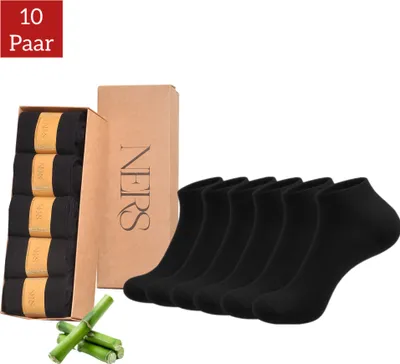A package of black socks with a cardboard box and bamboo stalks.