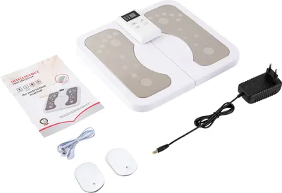 A white foot massager with its accessories and instruction manual laid out on a white background.