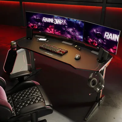 A gaming desk setup with multiple monitors, keyboard, mouse, and headphones, illuminated by red LED lighting.