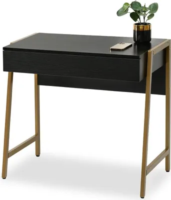 A black desk with gold legs and a small plant on top.