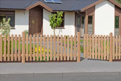 A wooden fence in front of a house.