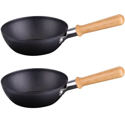 Two black woks with wooden handles are shown against a white background.