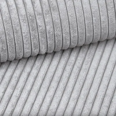 A close-up view of grey corduroy fabric, showing the texture and ribbed pattern.
