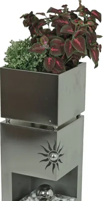A stainless steel planter column with plants.