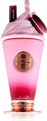 A pink perfume bottle shaped like a milkshake, decorated with a macaron and a straw.
