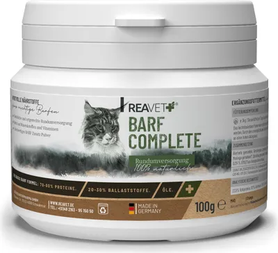 A white plastic container of cat food supplement powder, with a label featuring a cat and forest imagery.