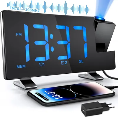 A digital alarm clock with a phone charging on its stand.