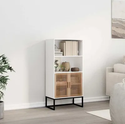 A white highboard with wooden slatted doors is placed in a room with a plant and a sofa in the background.
