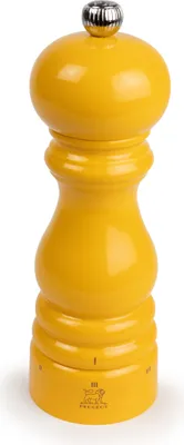A yellow pepper mill on a white background.