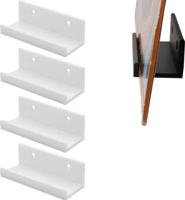 A collection of white L-shaped wall mounts for vinyl records, with one black mount holding a record on the right side of the image.