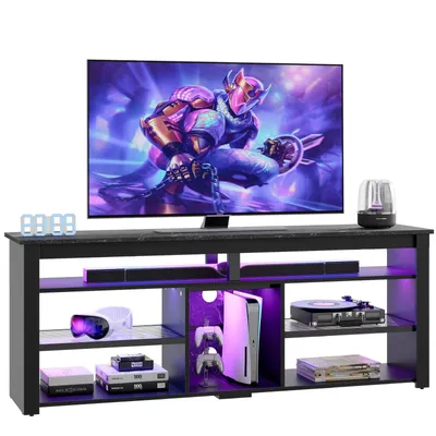 A modern black TV stand with LED lighting, displaying a large TV, gaming consoles, and other electronic devices.